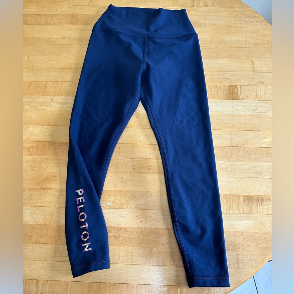 Peloton Navy Leggings with logo on side leg.